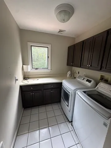 a kitchen with a sink a stove cabinets and utility room