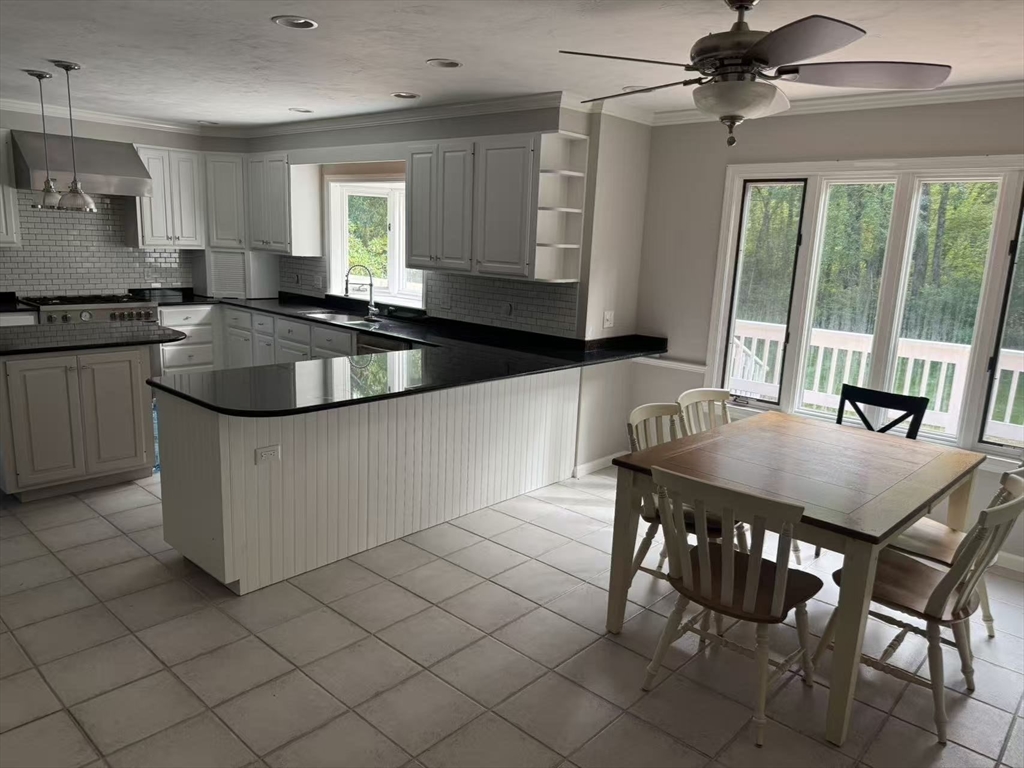 22 Capt Samuel Forbush Road Westborough, MA 01581 - Photo 5 of 38 a kitchen with granite countertop a sink chairs and cabinets