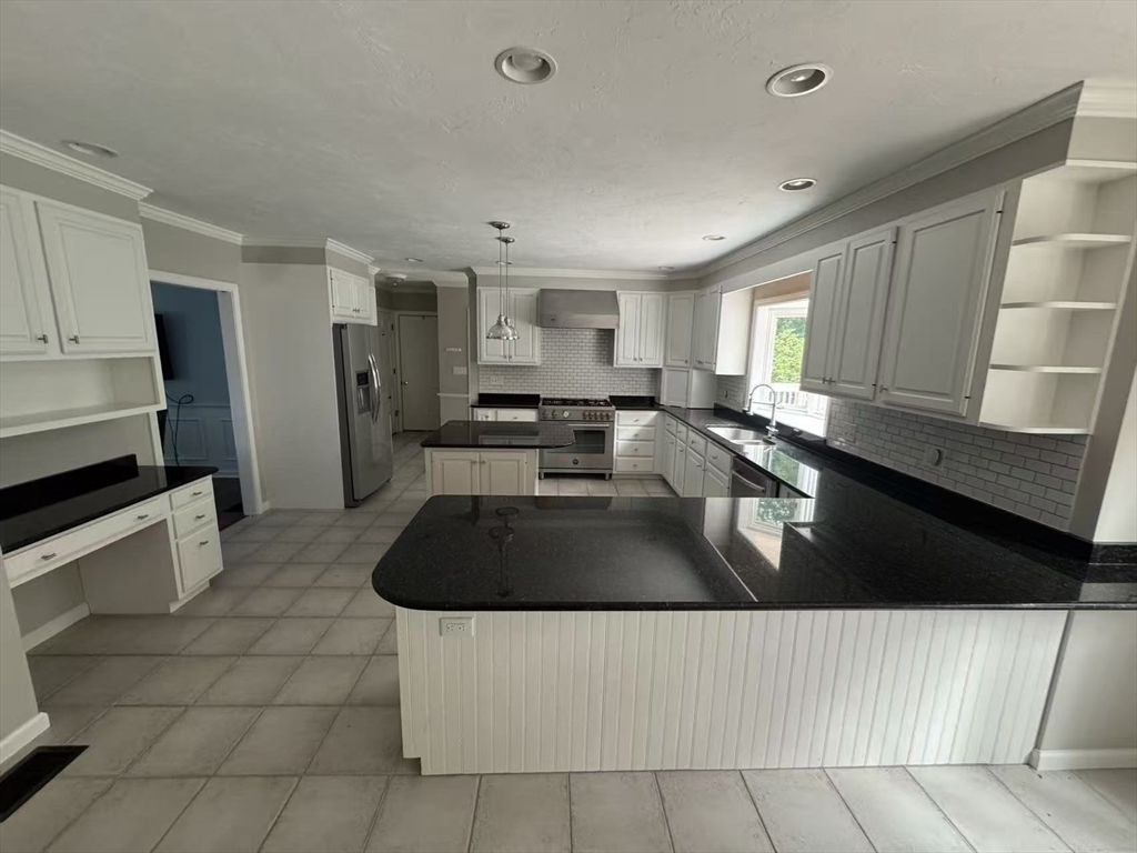 22 Capt Samuel Forbush Road Westborough, MA 01581 - Photo 6 of 38 a kitchen with a sink a stove and cabinets