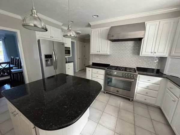 a kitchen with a stove a sink and a refrigerator