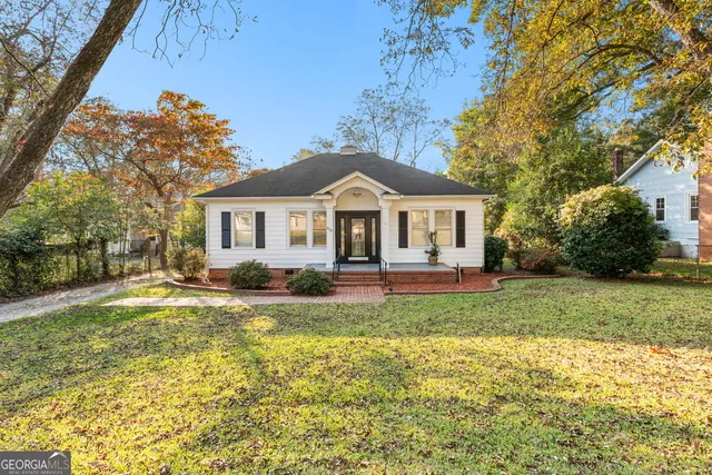 a front view of a house with a garden