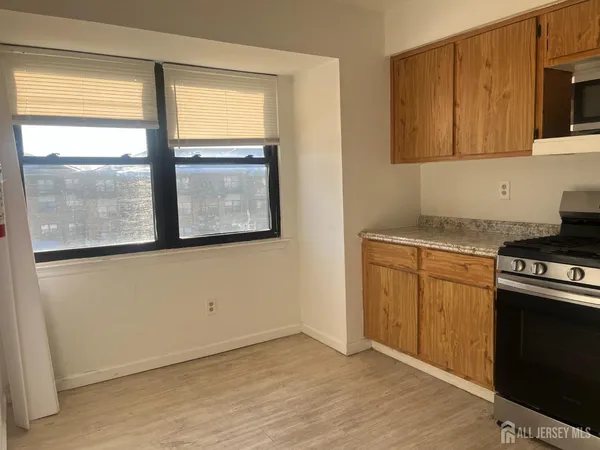 a kitchen with a stove microwave and cabinets
