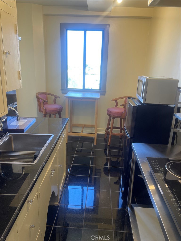 315 West 3rd Street, Unit 710 Long Beach, CA 90802 - Photo 4 of 14 a view of a workspace with furniture and a window