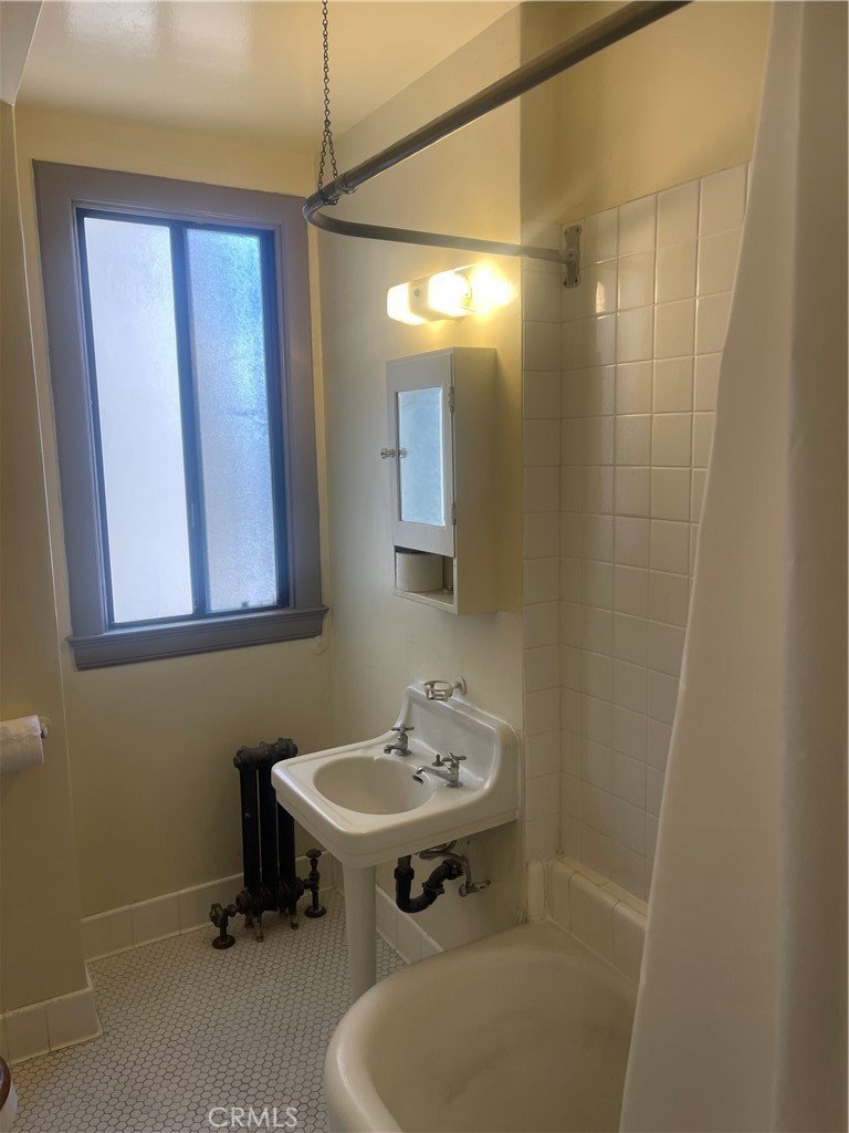 315 West 3rd Street, Unit 710 Long Beach, CA 90802 - Photo 9 of 14 a bathroom with a sink and a mirror