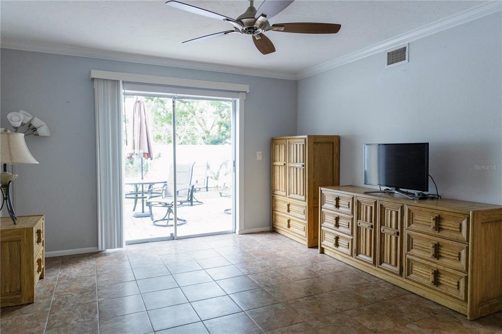 4805 Rilma Avenue, Unit 106 Sarasota, FL 34234 - Photo 13 of 24 a view of a livingroom with furniture and a flat screen tv