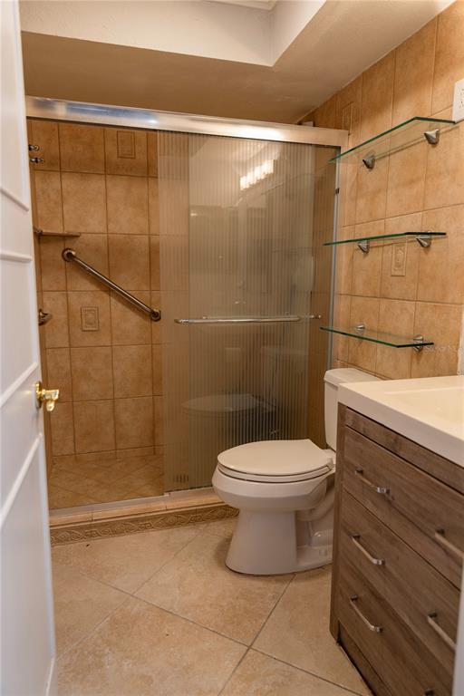 4805 Rilma Avenue, Unit 106 Sarasota, FL 34234 - Photo 18 of 24 a bathroom with a toilet and shower