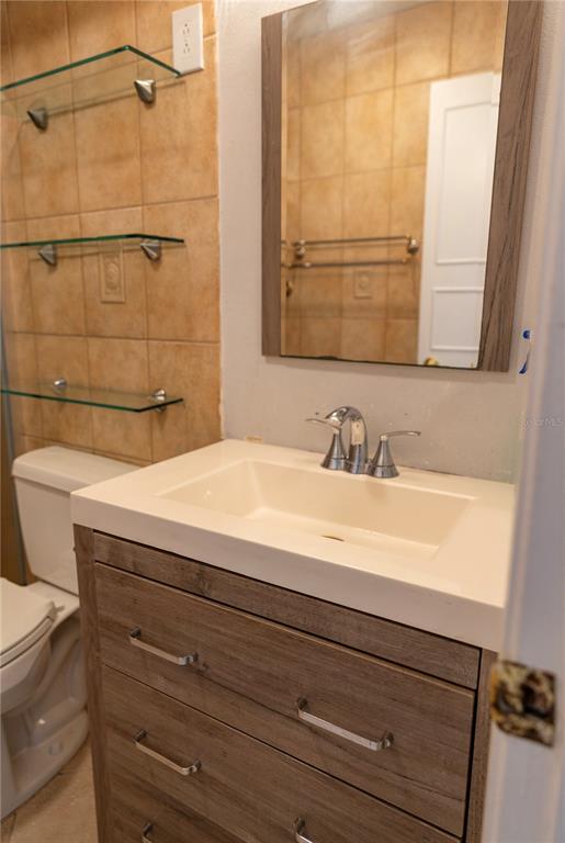 4805 Rilma Avenue, Unit 106 Sarasota, FL 34234 - Photo 19 of 24 a bathroom with a sink and a mirror