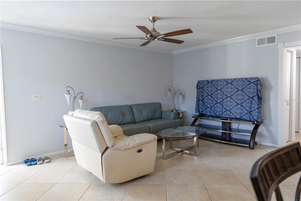 4805 Rilma Avenue, Unit 106 Sarasota, FL 34234 - Photo 3 of 24 a living room with furniture
