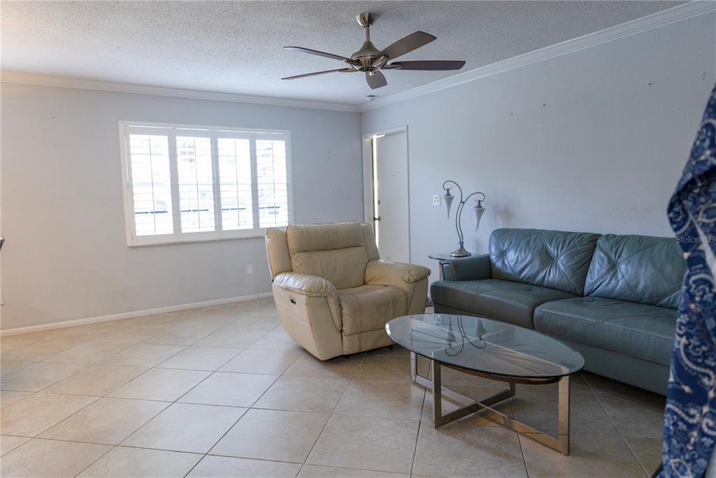 4805 Rilma Avenue, Unit 106 Sarasota, FL 34234 - Photo 4 of 24 a living room with furniture and a window