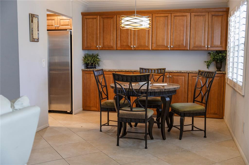 4805 Rilma Avenue, Unit 106 Sarasota, FL 34234 - Photo 5 of 24 a view of a dining room with furniture and chandelier