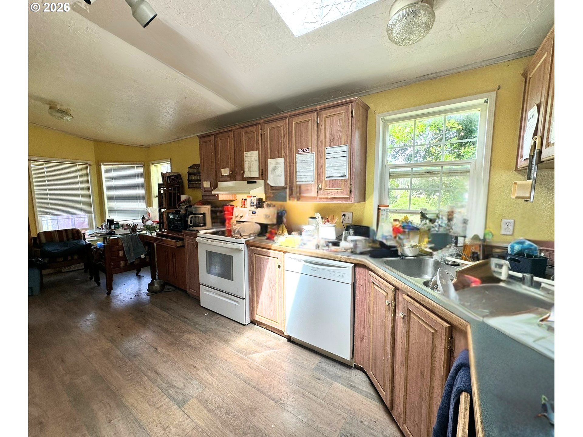 4821 Northeast 50th Street Neotsu, OR 97364 - Photo 7 of 19 a kitchen with a sink cabinets a counter top space and stainless steel appliances