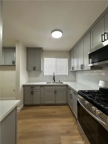 a kitchen with stainless steel appliances granite countertop a refrigerator and a stove