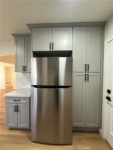 a kitchen with stainless steel appliances a refrigerator and a stove top oven