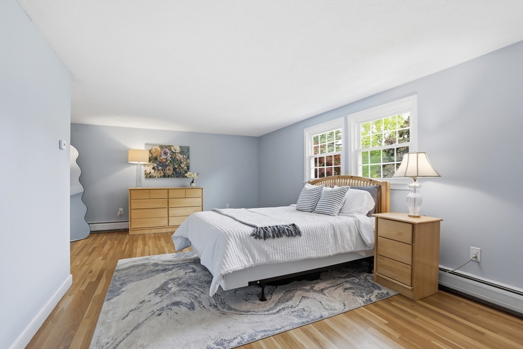 94 Johnson Road Winchester, MA 01890 - Photo 23 of 40 a bedroom with a bed and wooden floor