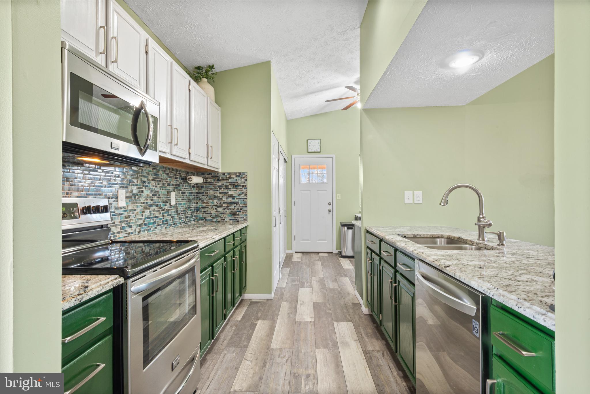 4535 Cub Run Road Chantilly, VA 20151 - Photo 17 of 49 a kitchen with stainless steel appliances granite countertop a stove and a sink