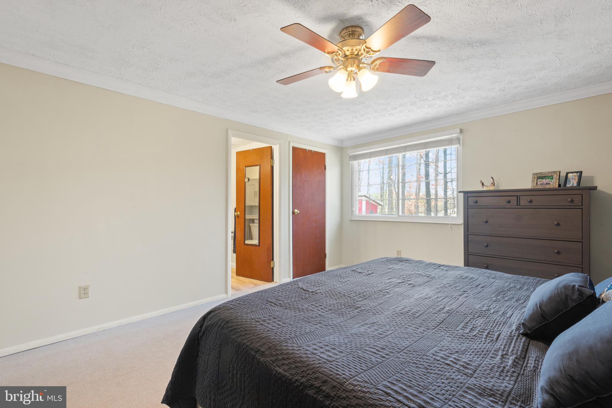 4535 Cub Run Road Chantilly, VA 20151 - Photo 25 of 49 a bedroom with a large bed and a chandelier