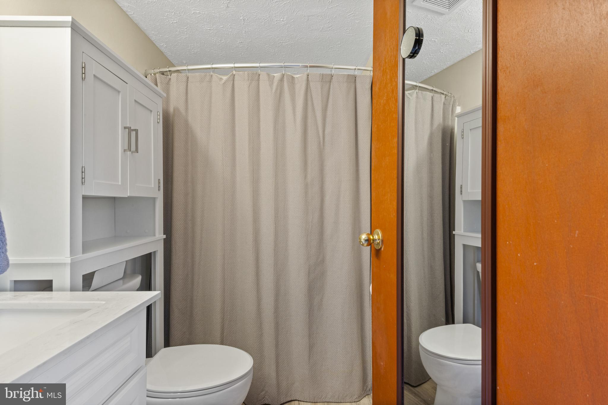 4535 Cub Run Road Chantilly, VA 20151 - Photo 27 of 49 a white toilet sitting next to a bathroom sink and a shower