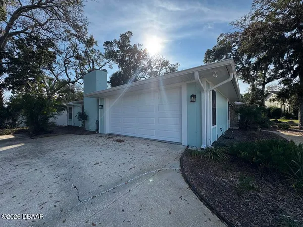 a view of a house with a yard and garage