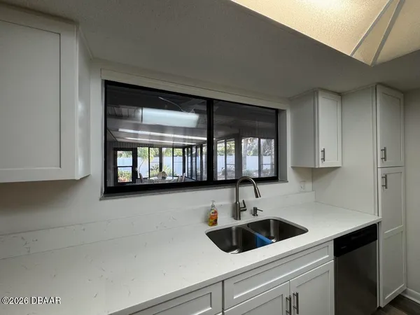 a view of a kitchen with a sink and cabinets