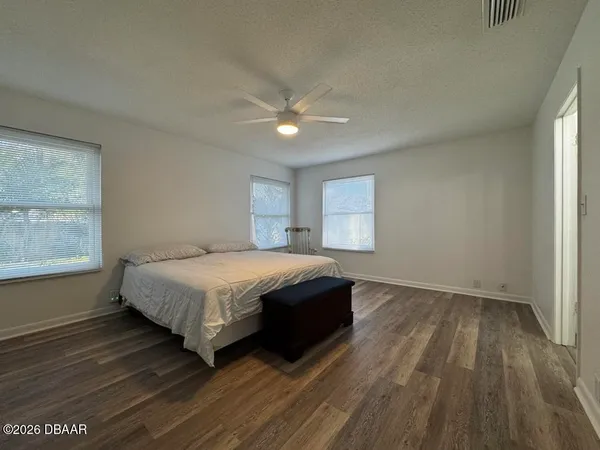 a spacious bedroom with a bed and a window
