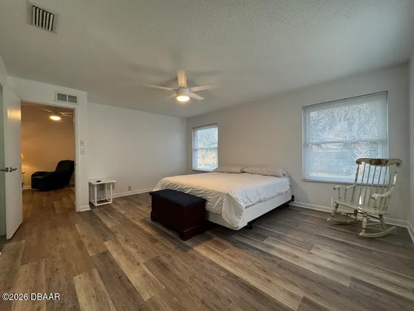 a bed room with a bed and a chair