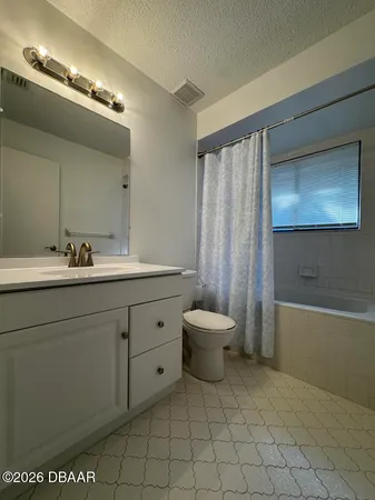 a spacious bathroom with a toilet sink and mirror