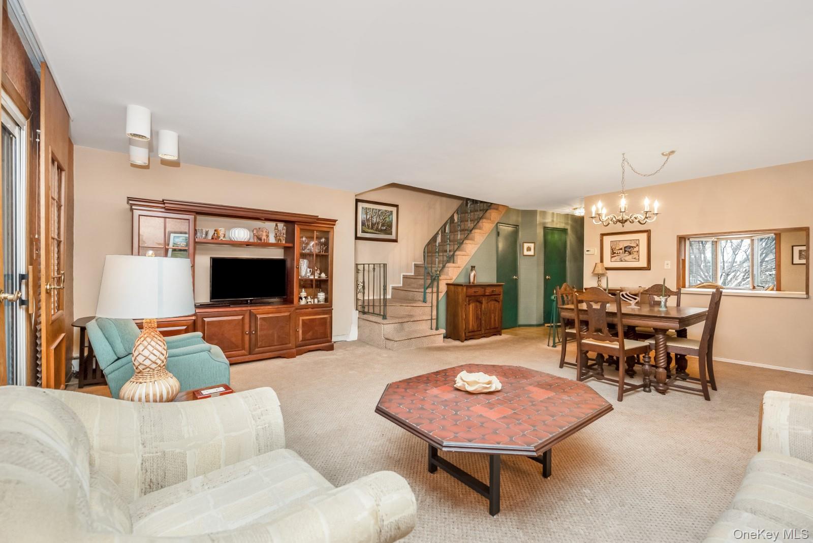 69-31 61st Road Queens, NY 11379 - Photo 11 of 28 a living room with furniture and a flat screen tv