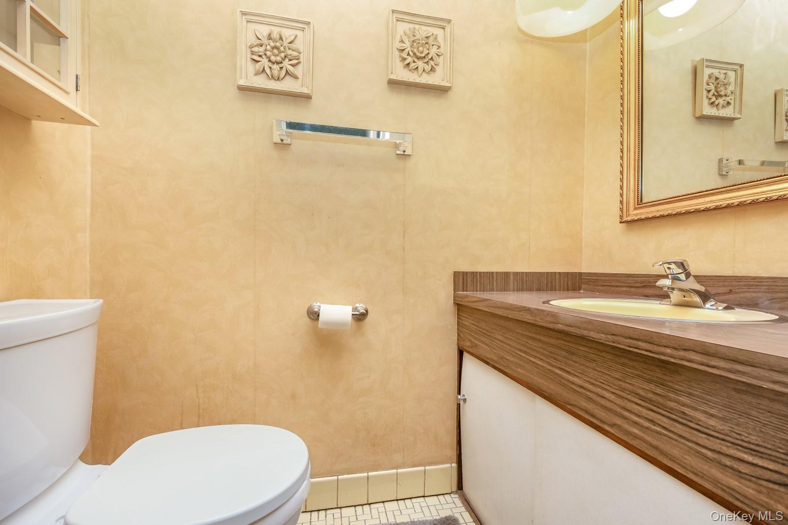 69-31 61st Road Queens, NY 11379 - Photo 12 of 28 a bathroom with a granite countertop sink toilet and a mirror