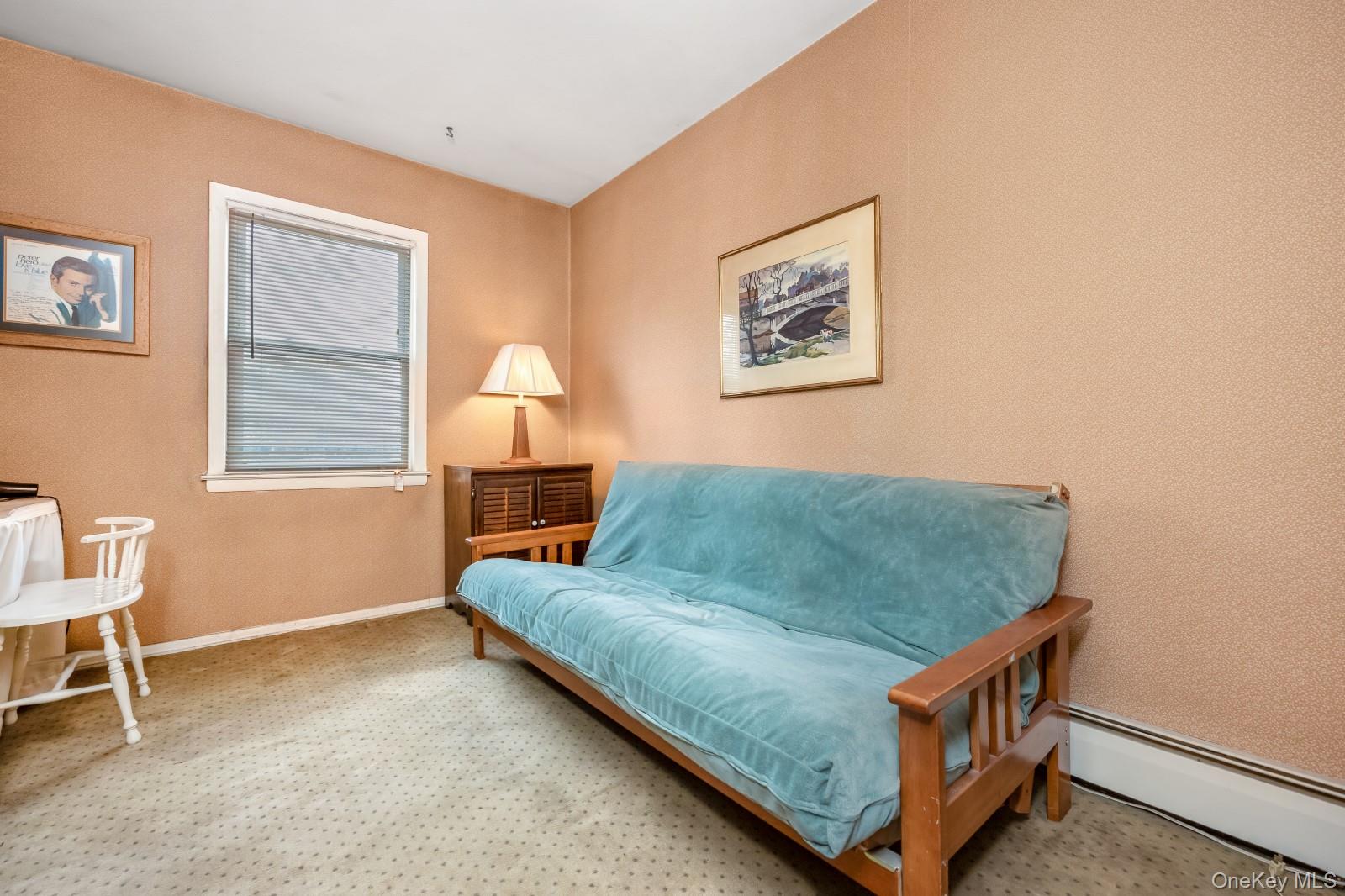 69-31 61st Road Queens, NY 11379 - Photo 16 of 28 a living room with a couch and a table