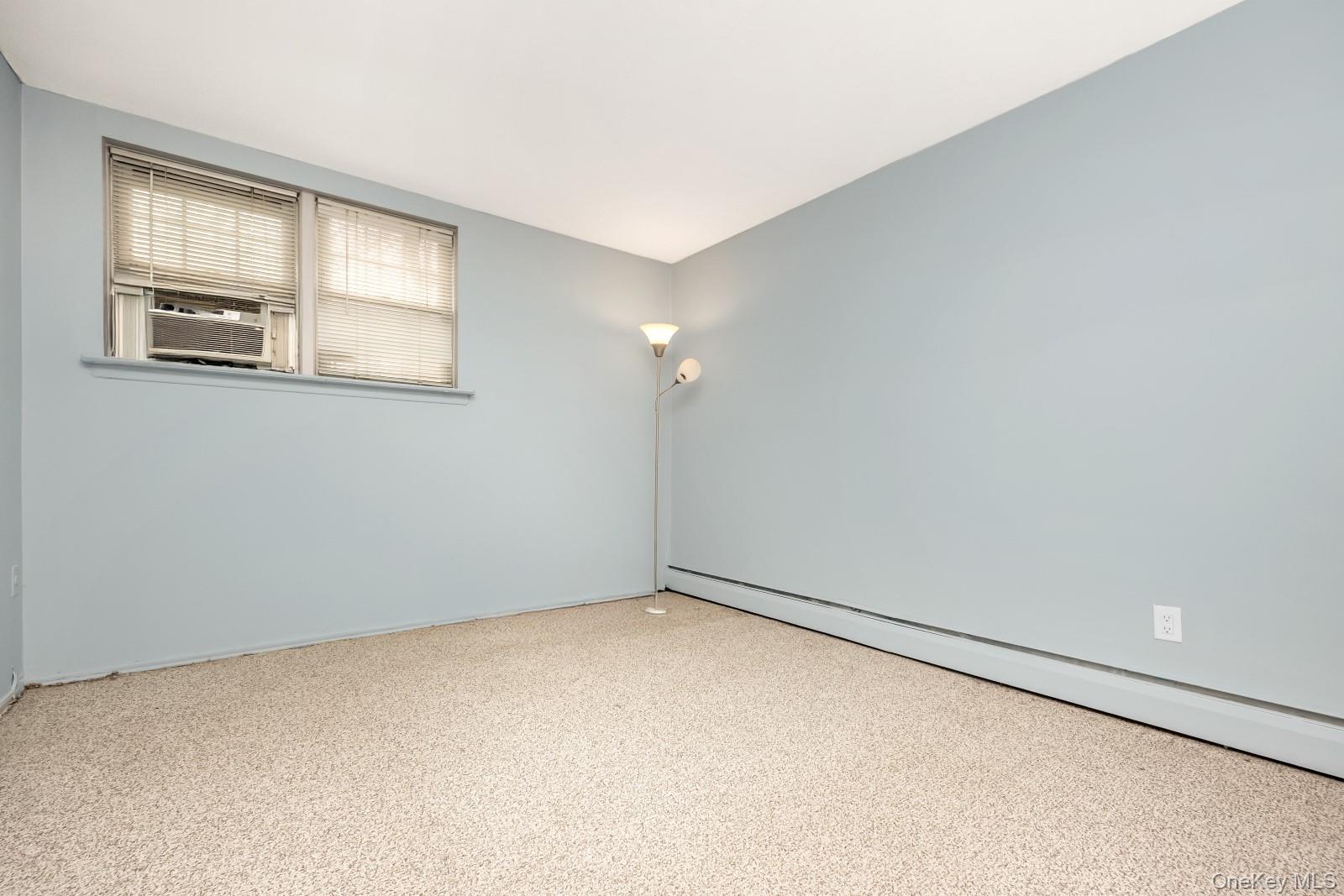 69-31 61st Road Queens, NY 11379 - Photo 20 of 28 an empty room with windows