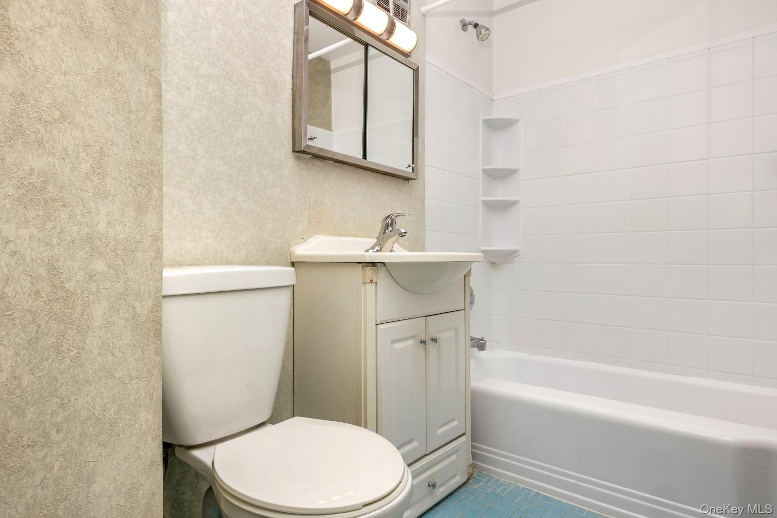 69-31 61st Road Queens, NY 11379 - Photo 22 of 28 a bathroom with a sink a toilet and bathtub