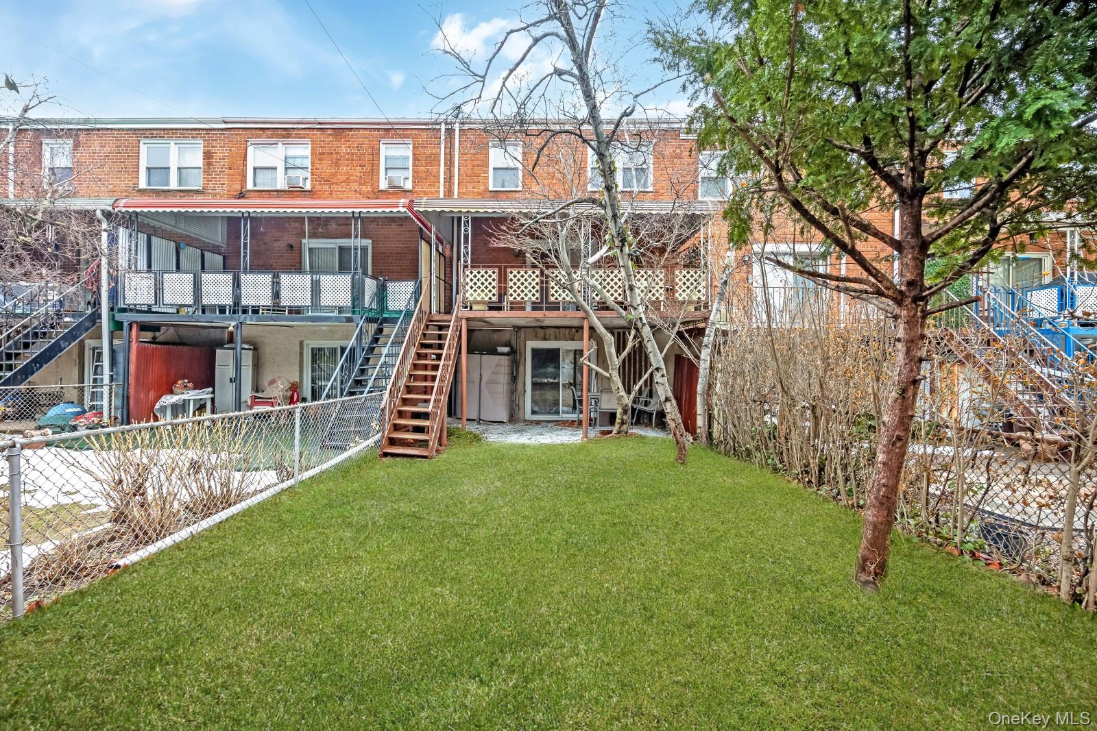 69-31 61st Road Queens, NY 11379 - Photo 28 of 28 front view of a house with a yard