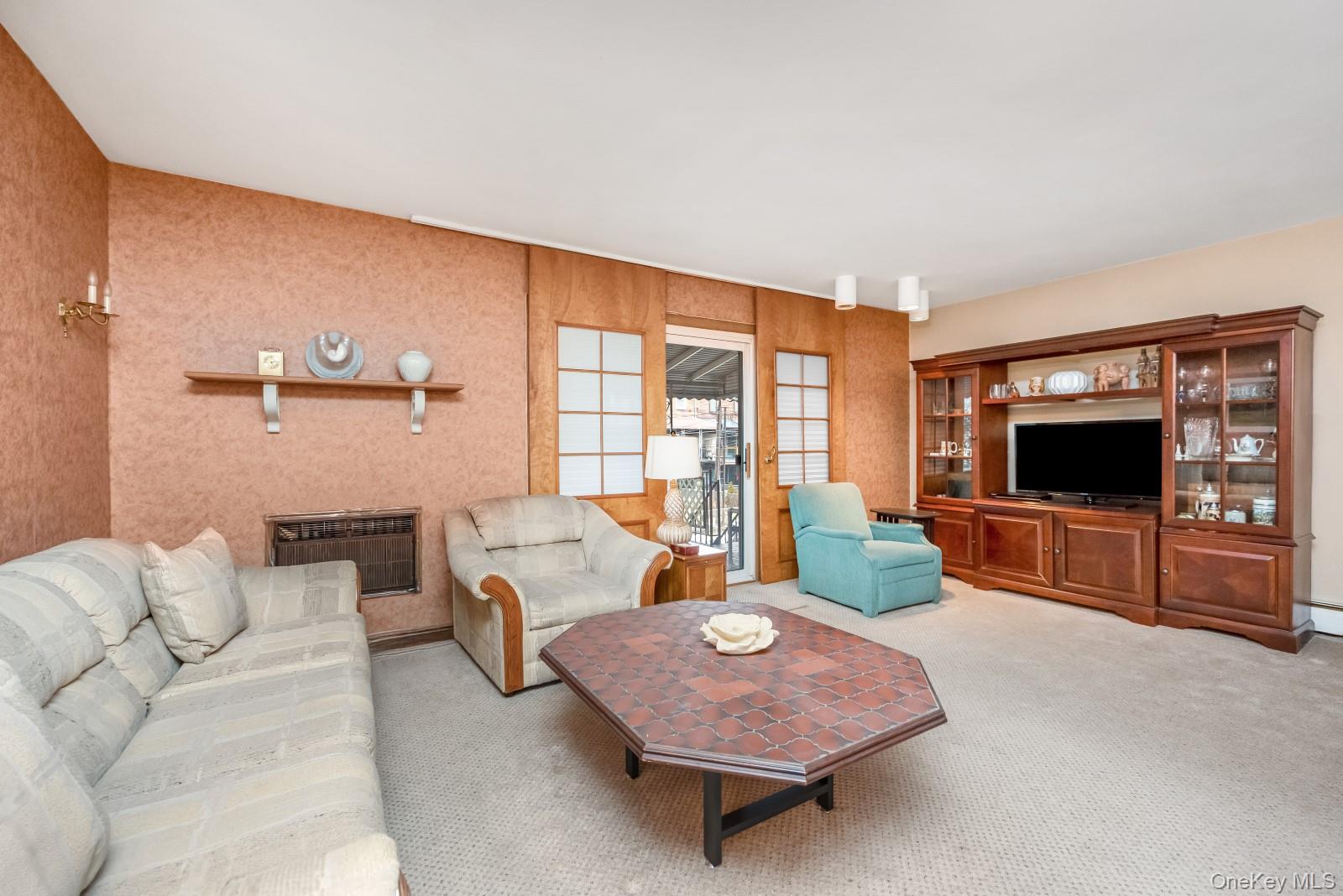 69-31 61st Road Queens, NY 11379 - Photo 8 of 28 a living room with furniture and a flat screen tv