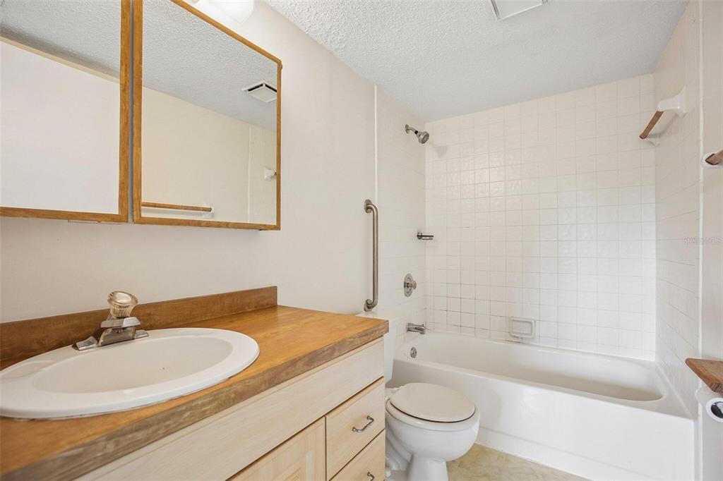 26485 Rampart Boulevard, Unit A27 Punta Gorda, FL 33983 - Photo 21 of 27 a bathroom with a sink a toilet and a bathtub