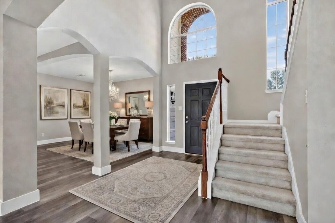20926 Trellis Lane Houston, TX 77073 - Photo 2 of 22 Entry and dining area as you walk in, with laminate flooring throughout the downstairs (virtually staged).