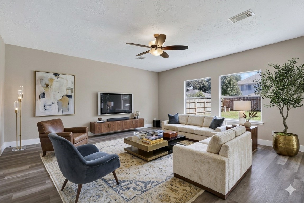 20926 Trellis Lane Houston, TX 77073 - Photo 3 of 22 The inviting living room boasts 10 ft ceilings and laminate flooring (virtually staged).