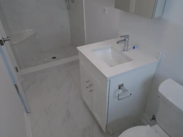 a bathroom with a sink toilet and shower
