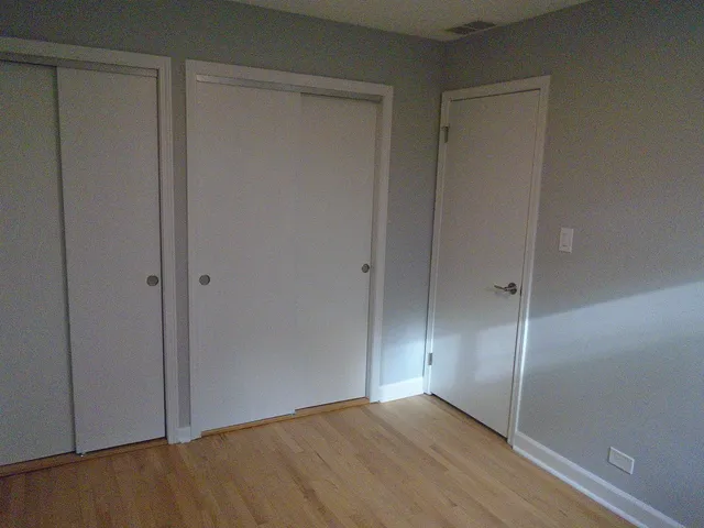 a view of an empty room with closet area