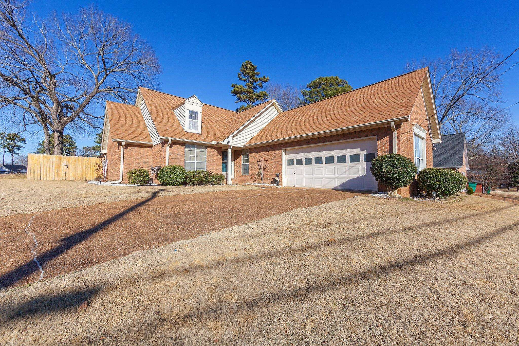 121 Windy Hill Road Jackson, TN 38305 - Photo 1 of 25 a front view of a house with a yard