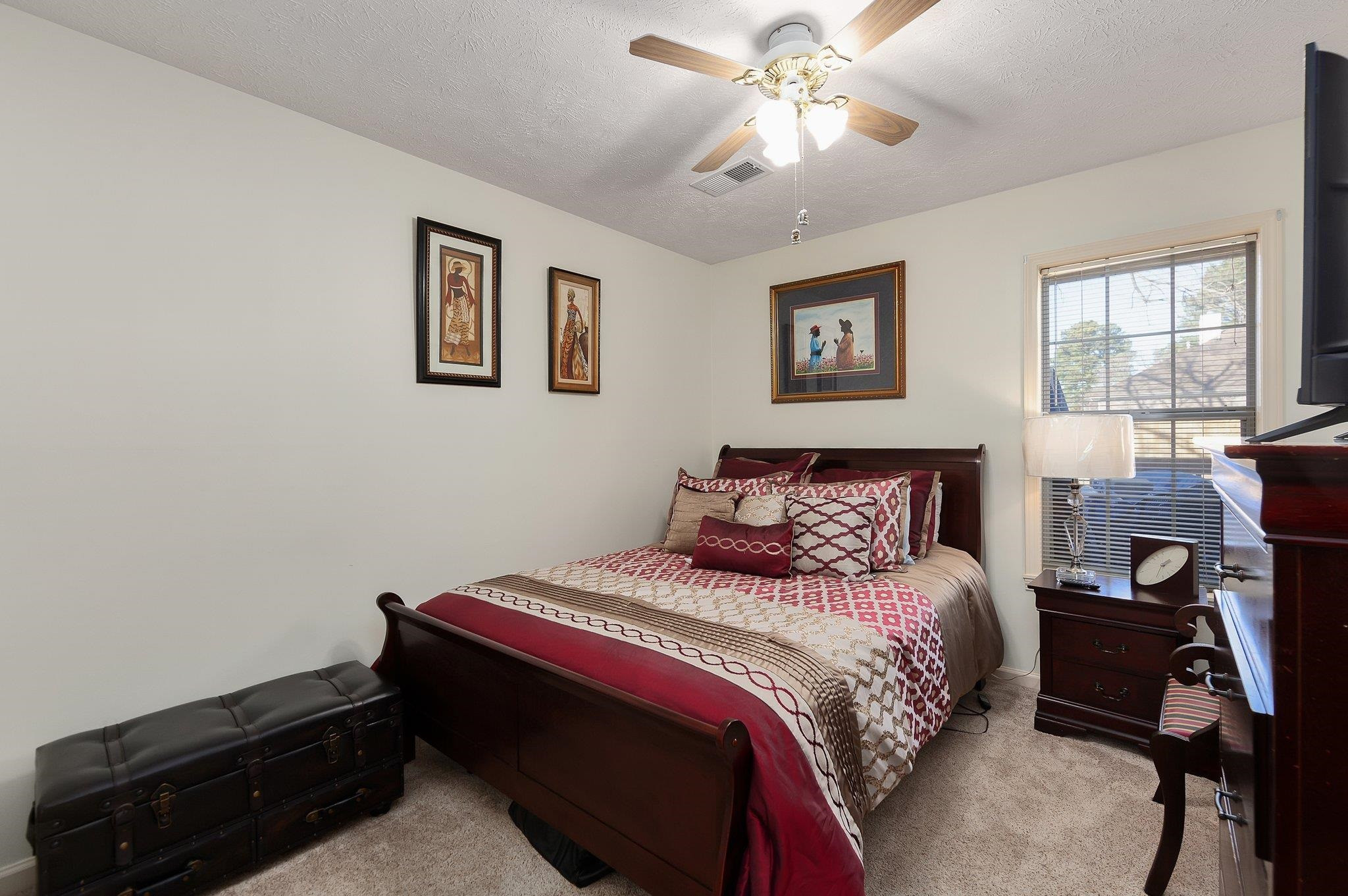 121 Windy Hill Road Jackson, TN 38305 - Photo 14 of 25 a bedroom with a bed and a chandelier