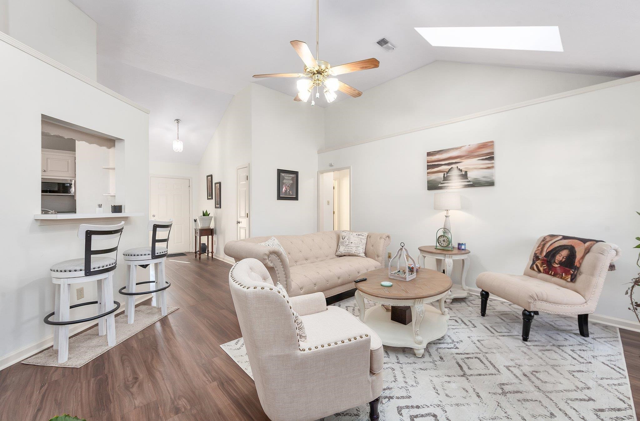 121 Windy Hill Road Jackson, TN 38305 - Photo 2 of 25 a living room with furniture a rug and a chandelier