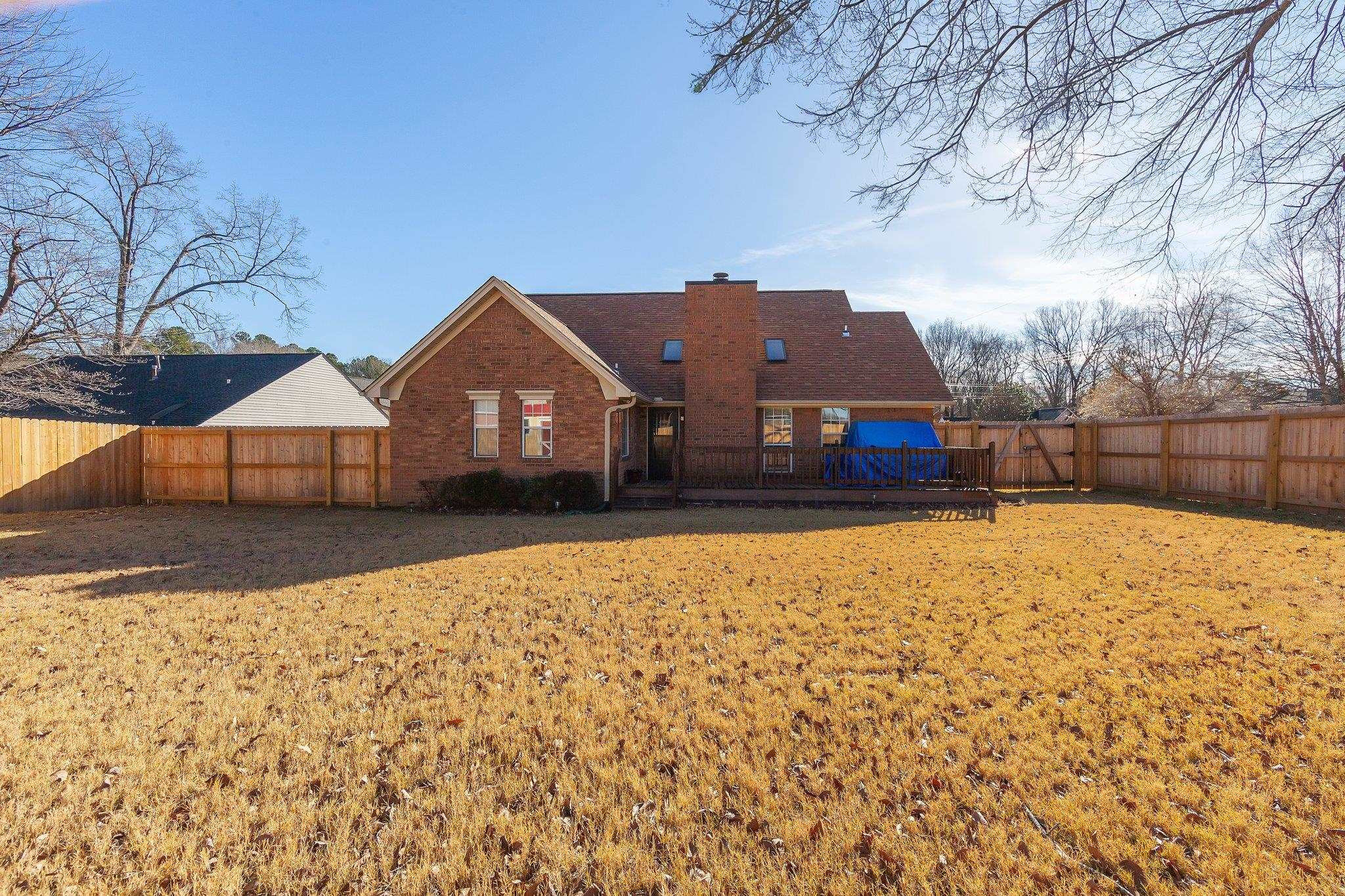 121 Windy Hill Road Jackson, TN 38305 - Photo 23 of 25 a front view of a house with a yard covered with snow in front of house