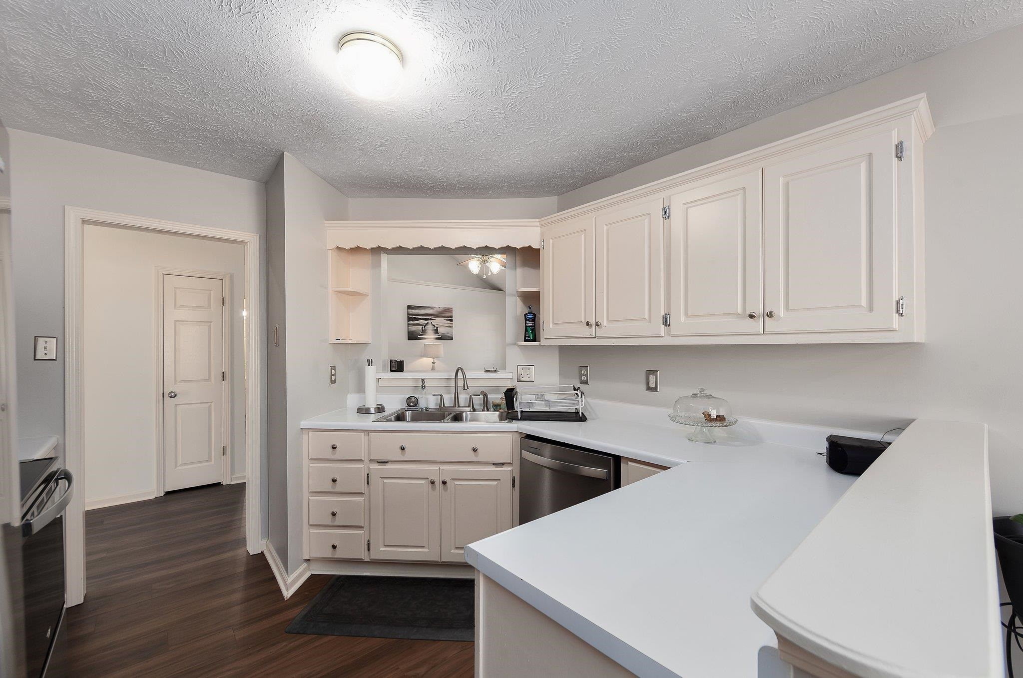 121 Windy Hill Road Jackson, TN 38305 - Photo 8 of 25 a kitchen with a sink a stove and cabinets