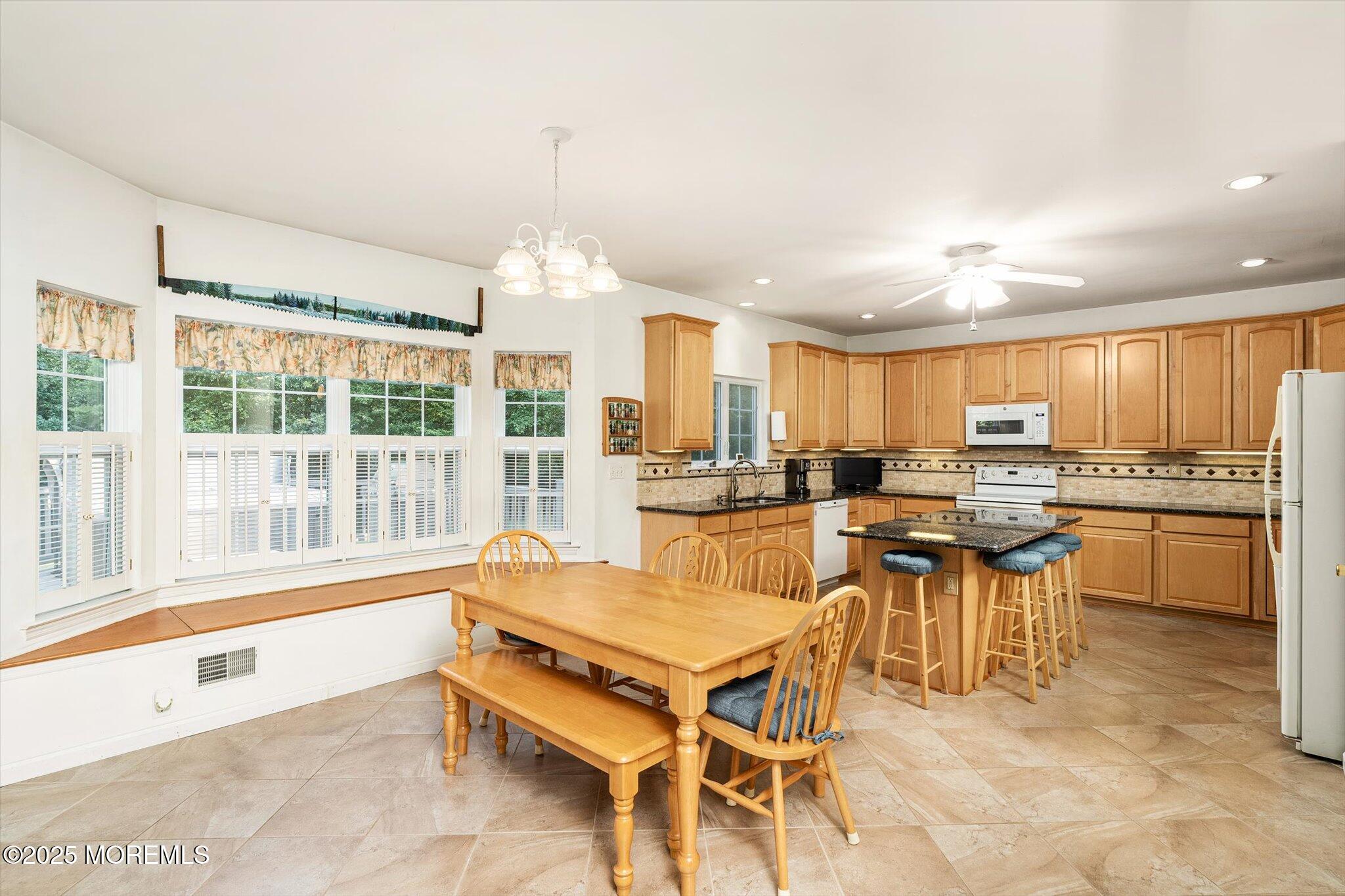 90 Sanders Lane Cream Ridge, NJ 08514 - Photo 13 of 48 a kitchen with a table chairs sink and cabinets
