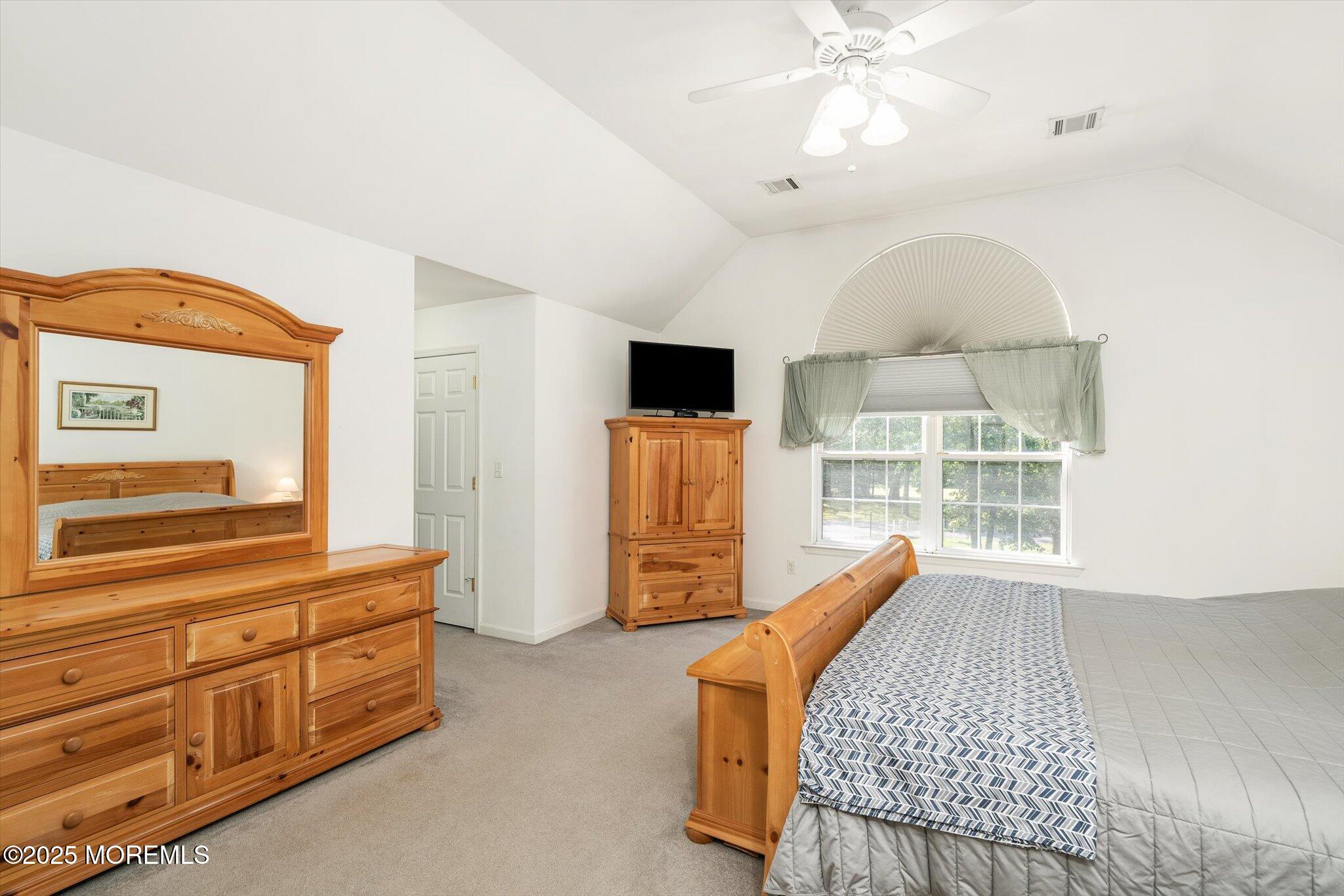 90 Sanders Lane Cream Ridge, NJ 08514 - Photo 19 of 48 a bedroom with furniture and a flat screen tv