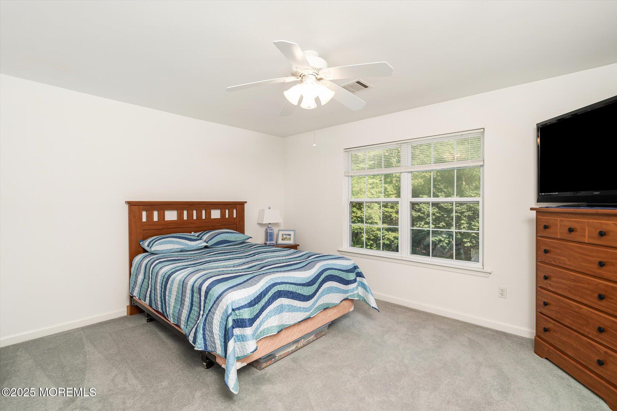 90 Sanders Lane Cream Ridge, NJ 08514 - Photo 27 of 48 a bedroom with a bed and a flat screen tv
