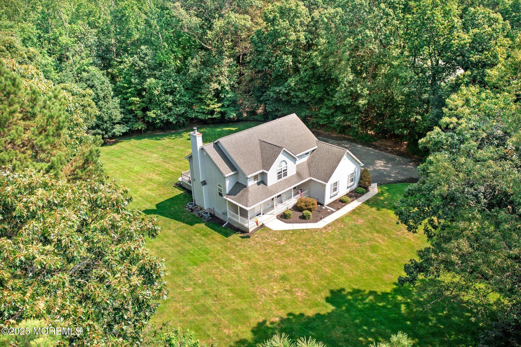 90 Sanders Lane Cream Ridge, NJ 08514 - Photo 44 of 48 an aerial view of a house with yard and trees in the background