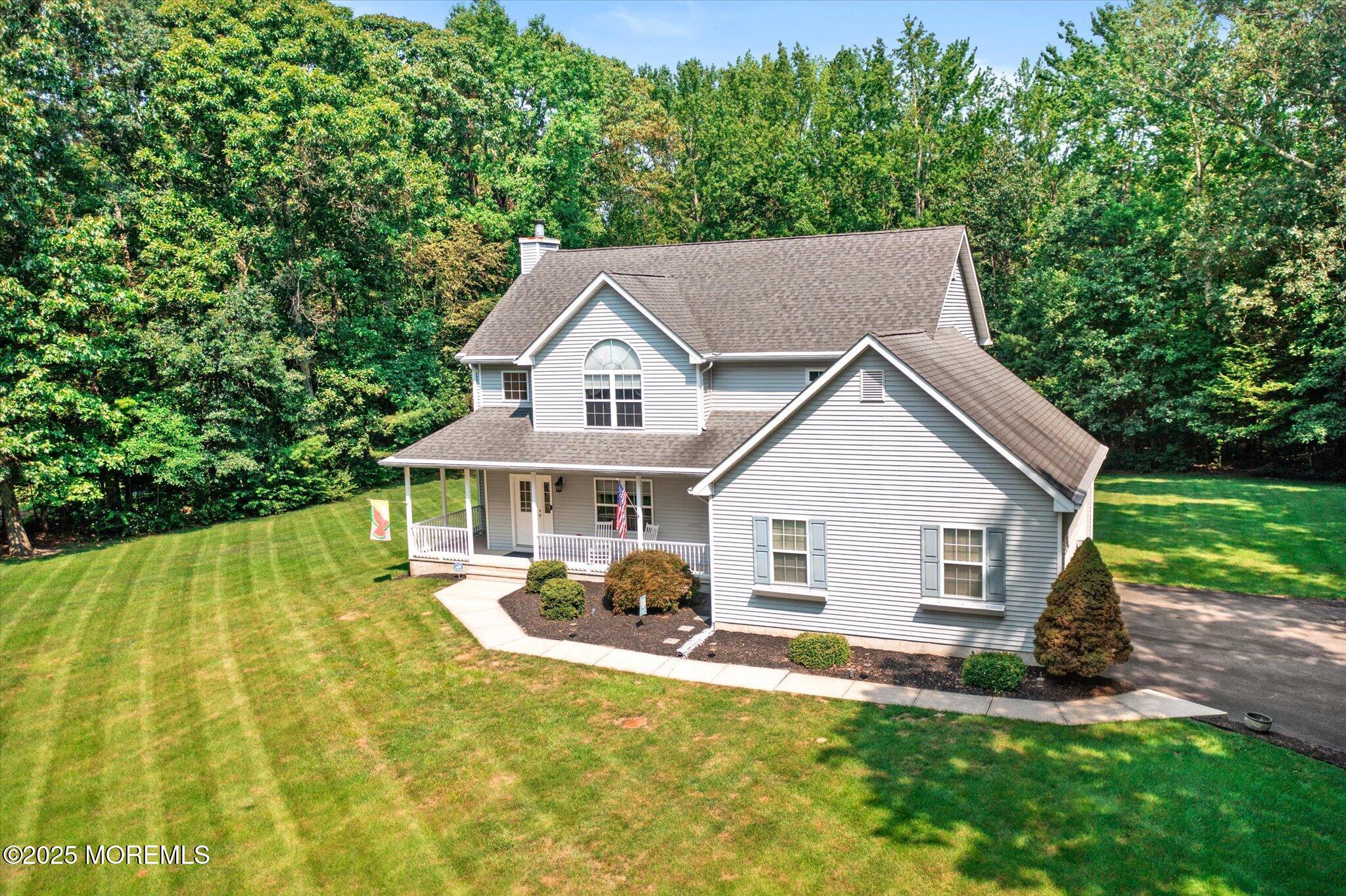 90 Sanders Lane Cream Ridge, NJ 08514 - Photo 45 of 48 a front view of a house with a yard table and chairs