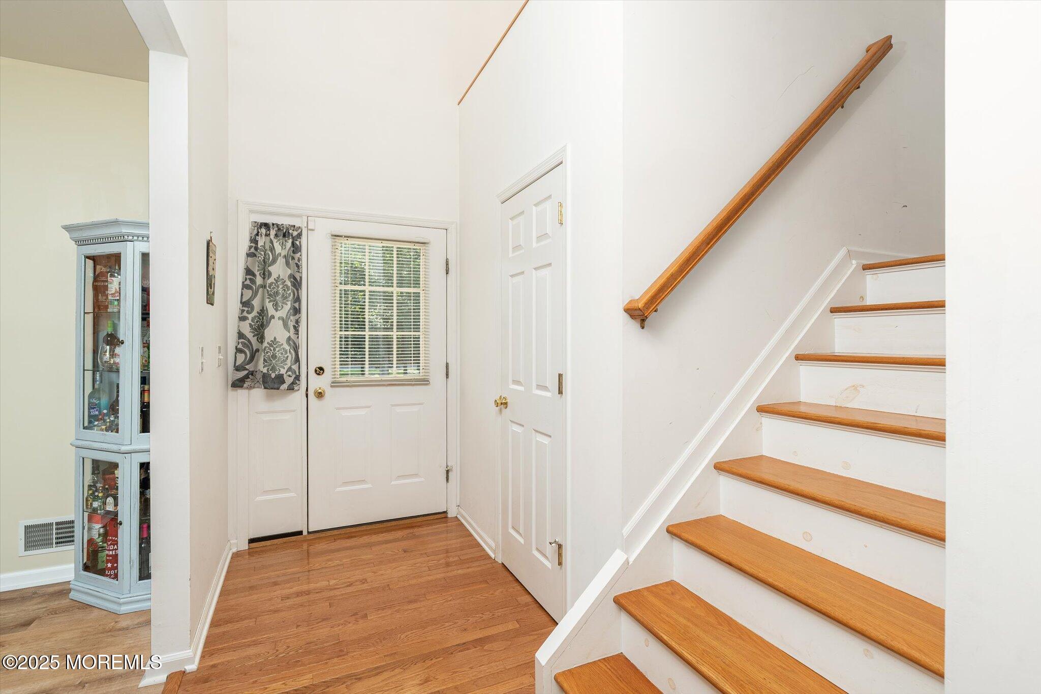 90 Sanders Lane Cream Ridge, NJ 08514 - Photo 8 of 48 a view of entryway with wooden floor and stairs