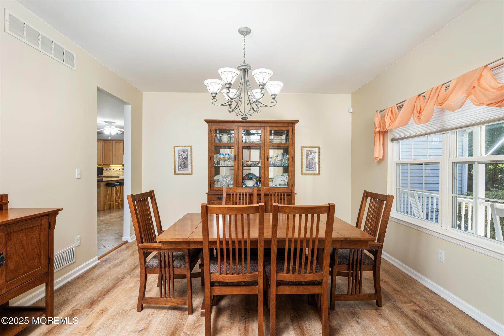 90 Sanders Lane Cream Ridge, NJ 08514 - Photo 10 of 48 a view of a dining room with furniture wooden floor and a chandelier